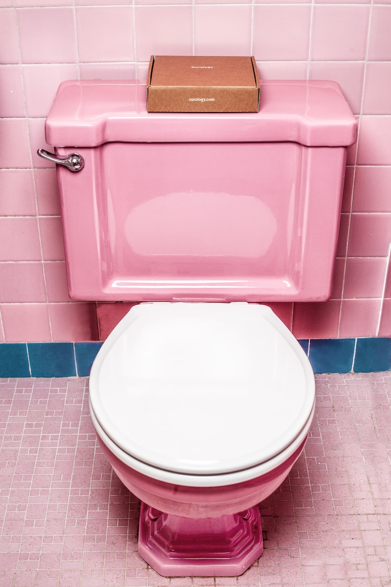 pink and white ceramic toilet bowl